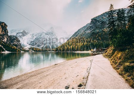 Great scene the alpine lake Braies (Pragser Wildsee). Location place Dolomites national park Fanes-Sennes-Braies, Italy. Europe. Cross processed retro and vintage style. Instagram effect. Beauty world