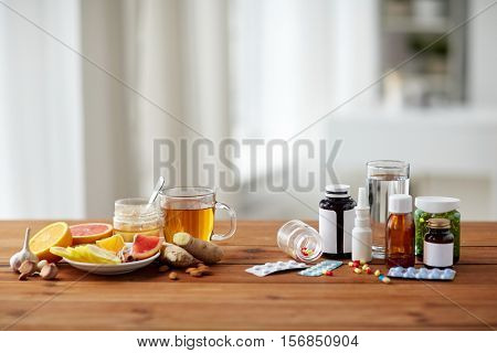 health, traditional medicine and ethnoscience concept - natural and synthetic drugs on wooden table
