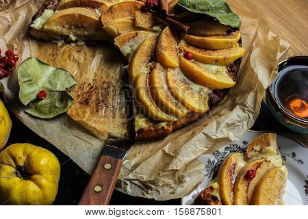 Homemade flour cake with quince and cooking utensils
