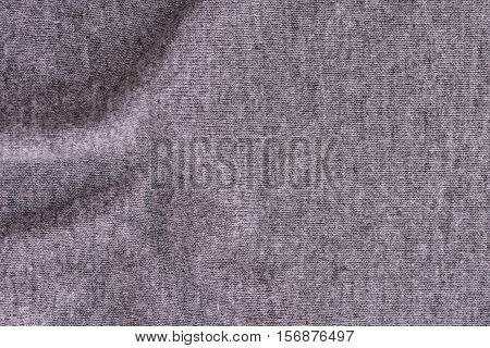 Close up of wrinkled dark grey bedsheet texture background.