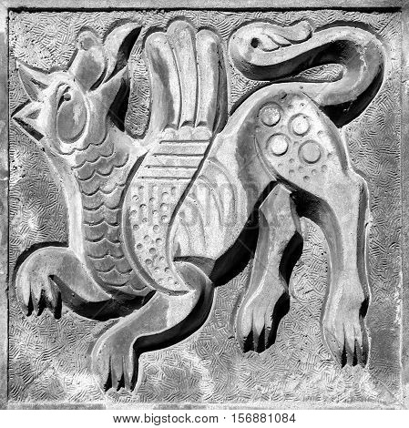 fairy winged agressive wolf bas-relief on the wall