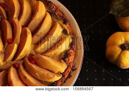 Homemade flour cake with quince and cooking utensils