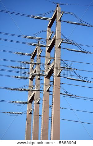 Powerlines against bright blue sky