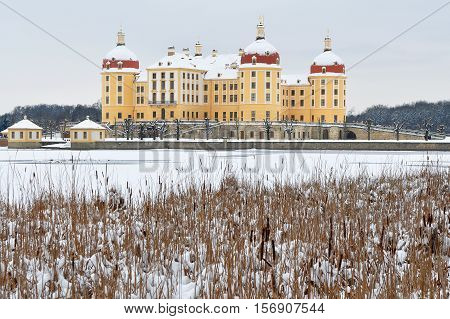 Moritzburg castle in background of lake in winter time