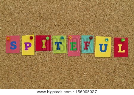 Spiteful word written on colorful sticky notes pinned on cork board.