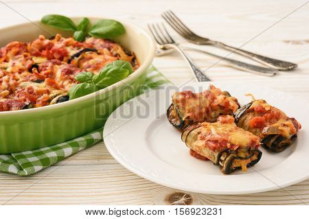 Roasted eggplants stuffed with minced meat and baked with tomatoes and cheese.