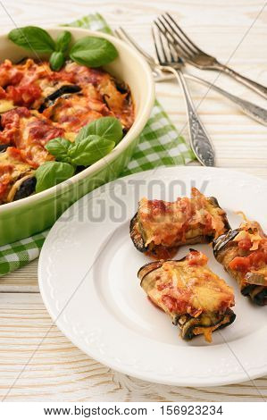 Roasted eggplants stuffed with minced meat and baked with tomatoes and cheese.