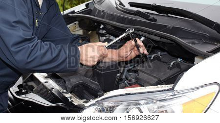Car mechanic with wrench.
