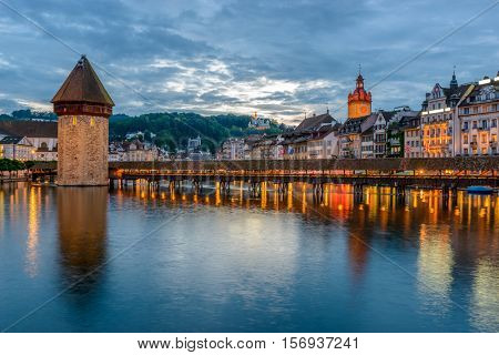 Night view towards Chapel Bridge (Kapellbruecke) together with the octagonal tall tower (Wasserturm) it is one of the Lucerne's most famous tourists attraction