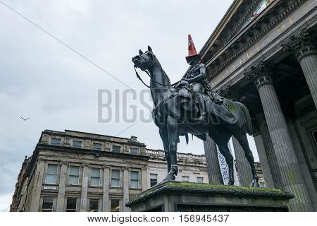 Statue Of Duke Of Wellington, Riding A Horse, Wearing A Traffic Cone On His Head. In Front Of Galler