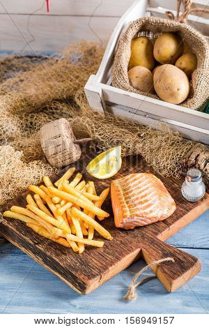 Tasty French Fries With Salmon Served On Plate