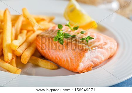 Homemade French Fries With Salmon Served On Plate