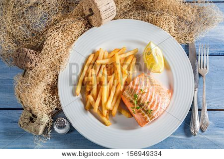 Delicious French Fries With Salmon Served On Plate