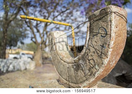 Horizontal photo in color of a sundial placed on a farm