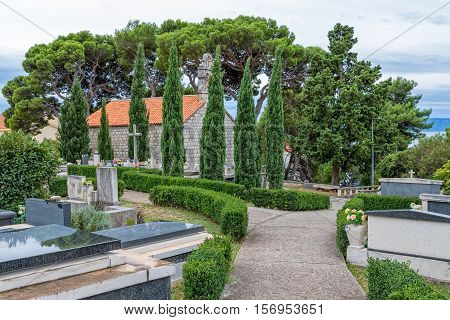 Virgin Mary church on graveyard in Tucepi, Croatia.