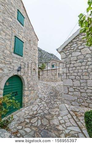Small narrow street in Tucepi village in the slope of a mountain Biokovo.