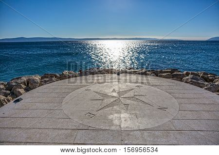 Beautiful stone compass on the Tucepi town beach.