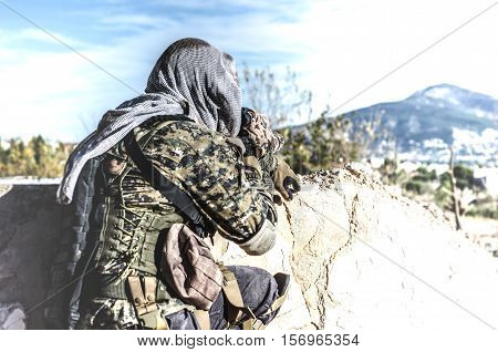 Sniper aim target scope ghillie suit camouflage lying on the floor