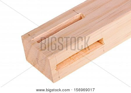 Close-up of the end of a pine board with two freshly cut woodworking mortises isolated against a white background