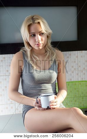 Thoughtfull woman drink coffee or tea in old mug