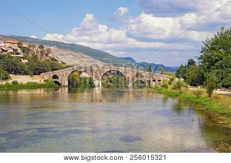 Beautiful River Landscape With Old Stone Bridge. Bosnia And Herzegovina, Trebinje, View Of Trebisnji