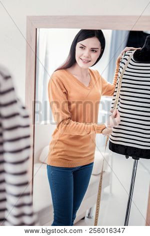 Joyful Dressmaker Using Measuring Tool On Mannequin