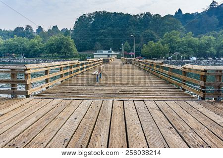 Smoke From Fires Creates A Haze Over A Pier And The Shoreline In Ruston, Washington.