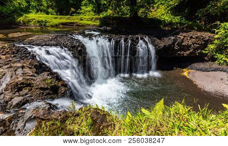 Vibrant Togitogiga falls with swimming hole on Upolu, Samoa Islands