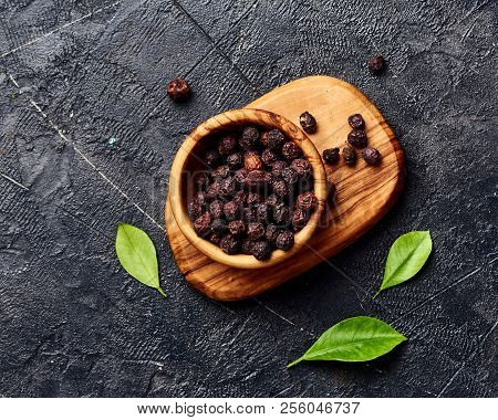 Dried Hawthorn Fruits On Black Background. Top View Of Crataegi Fructus.