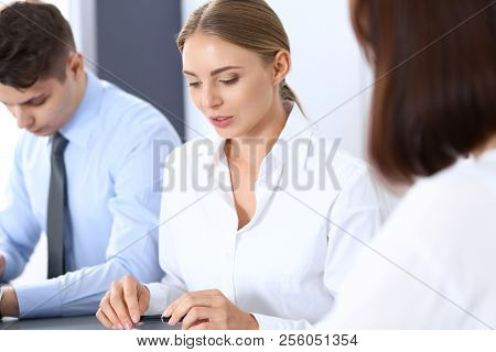 Group Of Business People Or Lawyers Discussing  Terms Of Transaction In Office. Meeting And Teamwork