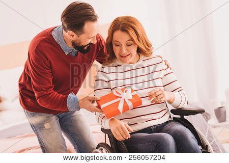 Cheerful Immobile Woman Getting A Present From Her Husband