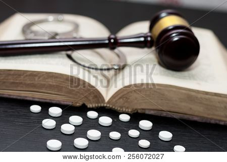 Judge's Gavel With Handcuffs, Drugs On Wooden Table