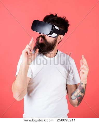 Man Bearded Hipster With Virtual Reality Headset On Red Background. Shooting Gallery Vr. First Perso
