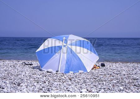 man sitting on pebble beach