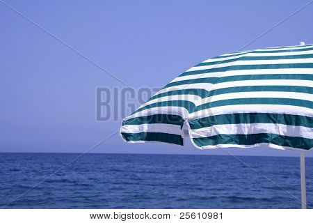 green and white striped parasol at seaside