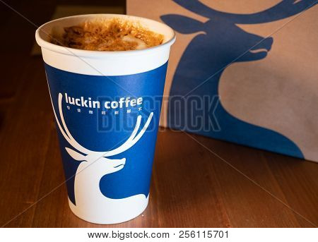 1 Septembre 2018, Wuhan China : A Caramel Macchiato Coffee Cup Of Luckin Coffee On Wooden Table Back