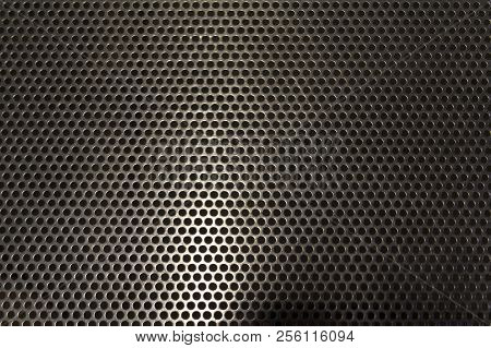 Metallic Background. Sheet Of Shiny Metal With Round Holes.
