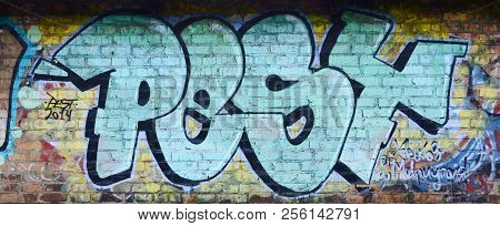 Full And Acomplished Graffiti Artwork. The Old Wall Decorated With Paint Stains In The Style Of Stre