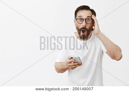 Man Impressed With New Features Of Phone. Portrait Of Shook And Surprised Good-looking Happy Mature 