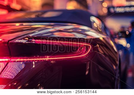 Taillight Or Rear Light Of Modern Car In Showroom. Red And Blue Toned Image