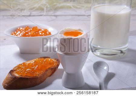 Morning Breakfast Set With Egg, Orange Jam On Bread Toast And Milk In Glass.