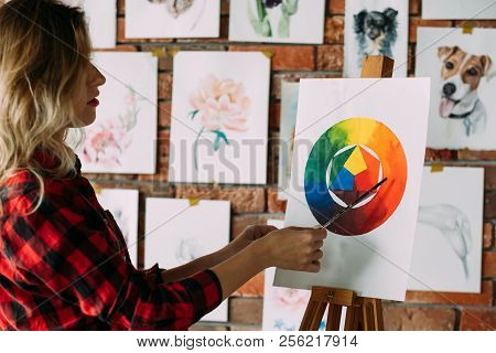 Painting Lessons And Art Classes. Teacher Explaining Dye Mixing Using Color Wheel. Skill Improvement