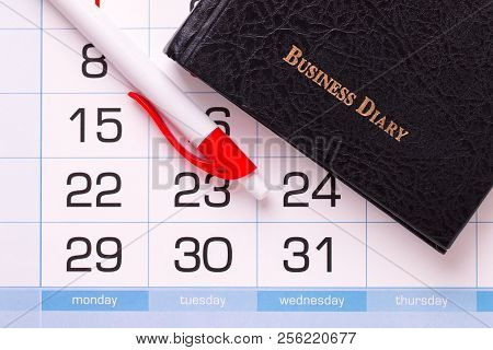 Diary For Entries And A Calendar With A Pen. Business Diary And Pen On A Calendar Background.