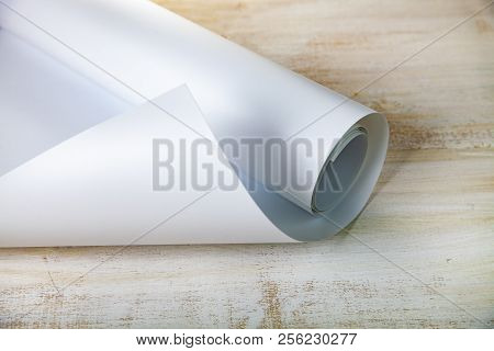 Roll Of White Paper On A Wooden Background.