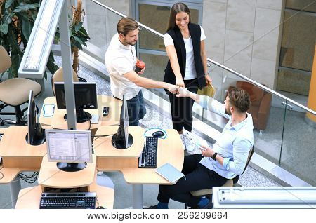 Top View Of Young Modern Colleagues In Smart Casual Wear Working Together While Spending Time In The
