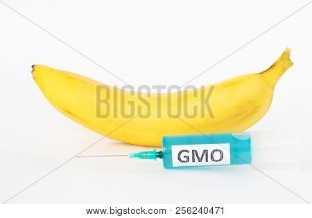 Banana On A White Background Next To Which Is A Syringe With Gmo And Nitrates, Close-up, Nitrates An