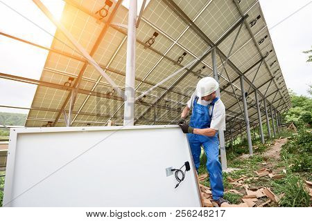 Installing And Wiring Of Stand-alone Solar Photo Voltaic Panel System In Green Field. Professional C