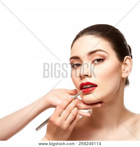 Girl Applying Red Lipstick Isolated On White