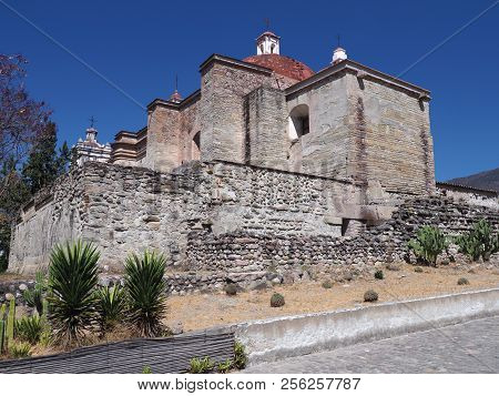 Side Of San Pedro Church In Mitla City, Cobble Road At Archeological Site Of Zapotec Culture In Oaxa