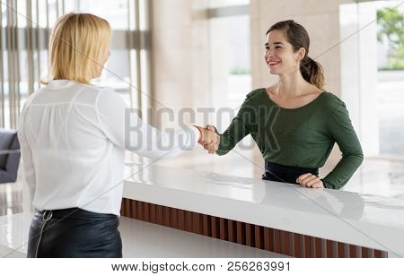 Office Receptionist Greeting Corporate Partner With Handshake. Woman In Formal Clothing Shaking Hand